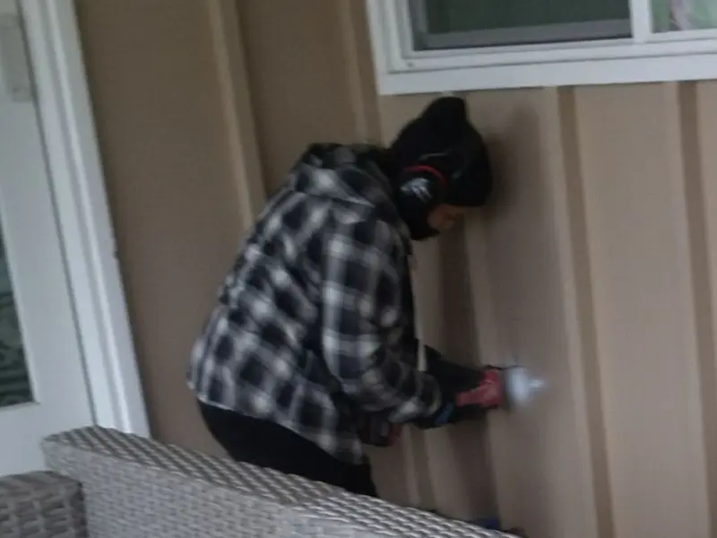 Professional electrician installing an exterior outlet in Claiborne